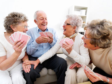 istockphoto_9976075-happy-senior-men-and-women-playing-cards
